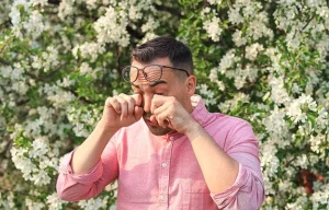 a-man-suffers-from-allergies-and-wipes-his-watery-eyes-Causes-of-Contact-Lens-Related-Infections-ss-body