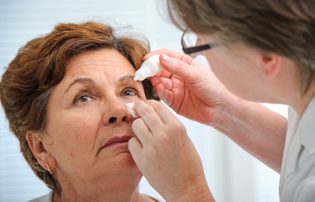 doctor helps patient gives eye drops How to Treat Presbyopia