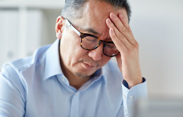 man having headache What Is Presbyopia